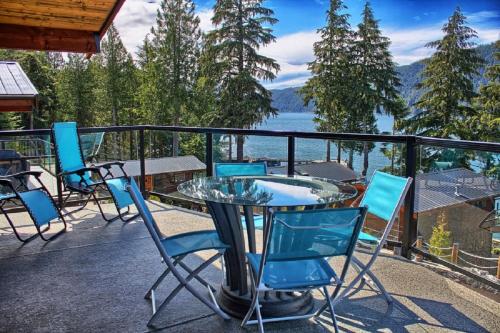a patio with chairs and a table on a balcony at Fish Tales Cottage in Port Renfrew