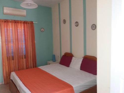 A bed or beds in a room at Panormos,Irene's Studio