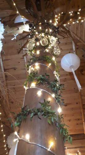 a large vase with plants on it with lights at Tawerna-Stawiska in Garbatka-Letnisko