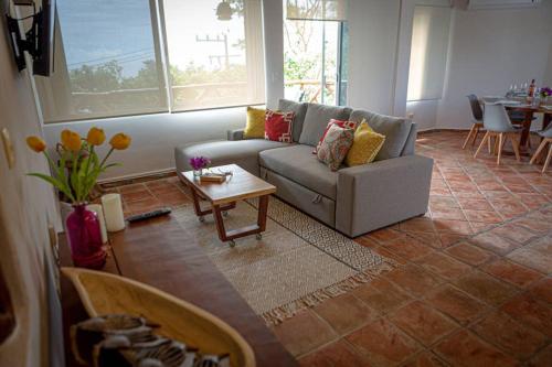 a living room with a couch and a table at Casa Marene in Puerto Morelos