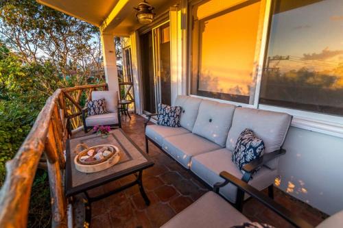 a porch with a couch and a table on a house at Casa Marene in Puerto Morelos