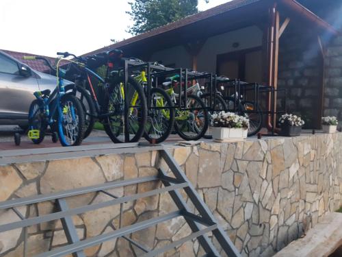 a row of bikes parked on a stone wall at Apartmani Gmitrovic in Rtanj