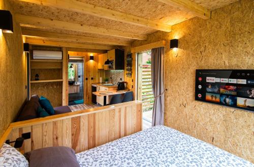 a room with a bed and a view of a kitchen at Welcome to Gerês-Green view in Vieira do Minho