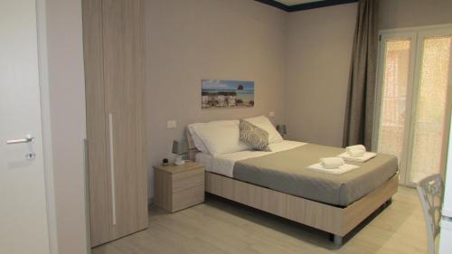 a small bedroom with a bed and a window at Zagara in Trapani