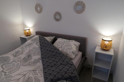 a bedroom with a bed and two night stands at Clermont Centre- Appartement Privé in Clermont