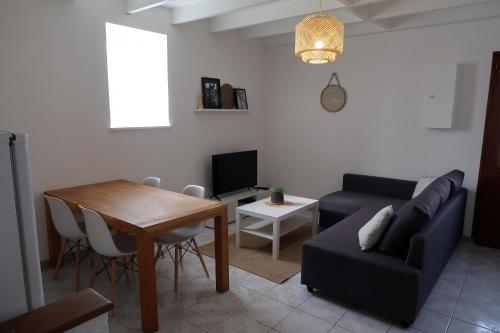 a living room with a couch and a table at Clermont Centre- Appartement Privé in Clermont