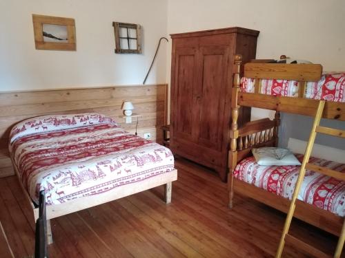 a bedroom with two beds and a bunk bed at Locazione turistica Lou Bindel in Sampeyre
