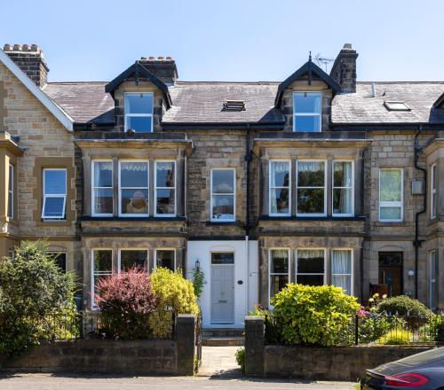 a large brick house with a white door at Wynnstay House in Harrogate