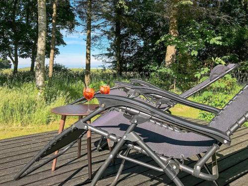 einen Tisch und einen Stuhl auf einer Terrasse in der Unterkunft 6 person holiday home in Nyk bing M in Hesselbjerg