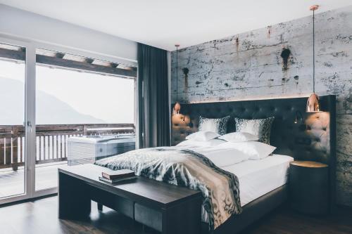 a bedroom with a large bed and a table at Golserhof in Tirolo