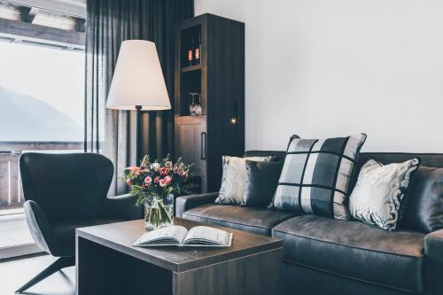 a living room with a couch and a table with books at Golserhof in Tirolo