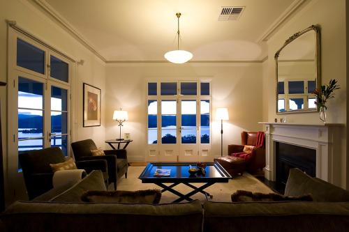 a living room with a couch and a table at Villa Talia Tasmania in Wattle Grove