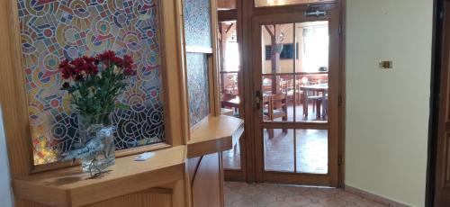 a room with a vase of flowers on a counter at hotel ZLATÝ POTOK in Nicov