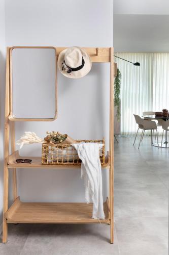 a mirror on a shelf in a room at Alonas Apartments Beachfront Apartment in Haifa