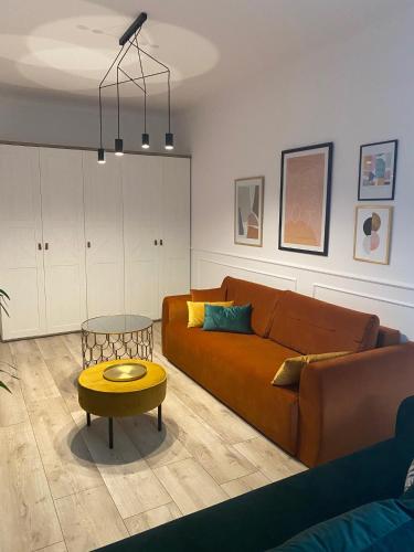 a living room with a couch and a table at Apartament BellaPola Loft in Nysa