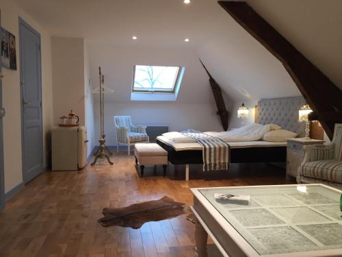 een slaapkamer met een bed en een tafel in een kamer bij French Corréze Moulin Bleu in Saint-Pantaléon-de-Larche