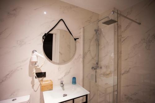 a bathroom with a shower and a sink and a mirror at CC Malasaña in Madrid