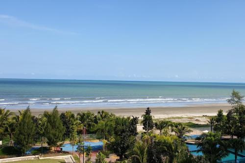a view of the beach from the balcony of a resort at Timurbay Seafront Residence & Suites in Kuantan