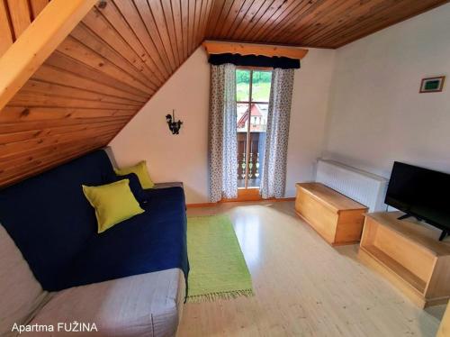 a living room with a couch and a piano at Apartment Cesar in Bohinj
