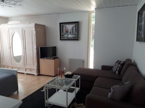 a living room with a couch and a table at Apartment Steinsgård-Maura in Maura