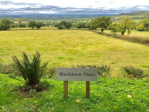 a sign that says blacktown views in a field at Blackdown Views - New 6 Bedroom Eco House in Dunkeswell