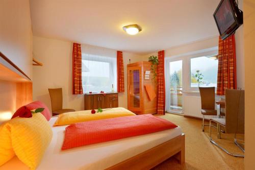 a bedroom with two beds and a television in it at Ferienhaus AB in Söll