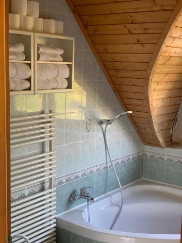 a bathroom with a bath tub in a room at House4U in Balatonszemes