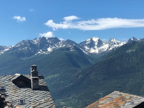 a view of snow capped mountains from a roof at Chalet Morge in La Salle