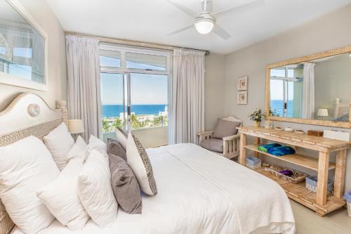 a bedroom with a large bed with a view of the ocean at 43 Sea Lodge - by Stay in Umhlanga in Durban