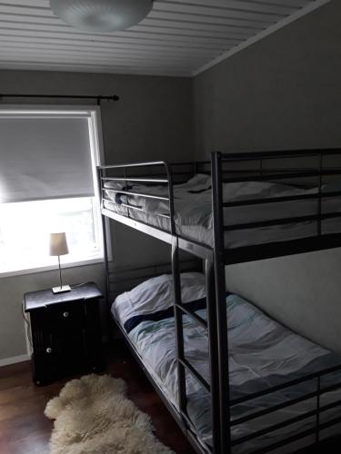 a bunk bed room with two bunk beds and a rug at The Cottage Badelunda in Västerås