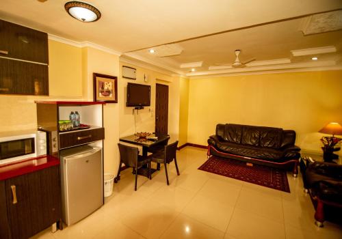 a living room with a couch and a table at Urban Rose Hotel & Apartments in Dar es Salaam