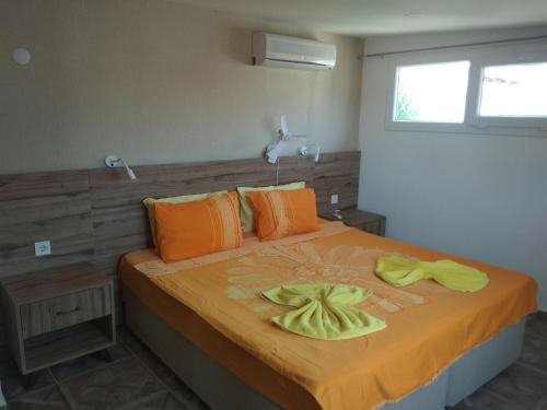 a bedroom with a bed with two towels on it at Paddys Apartments Ovacık in Oludeniz