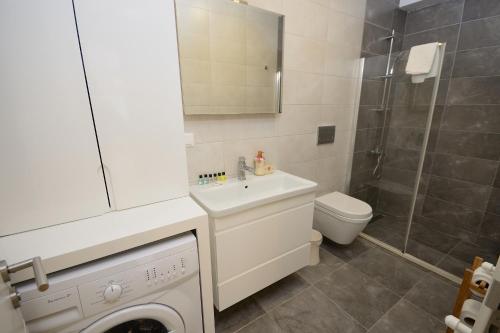 a bathroom with a sink and a toilet and a shower at Saatli Suites in Cesme
