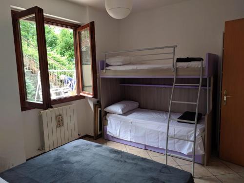 a room with a bunk bed and a ladder at SWEET VIEW in Varenna