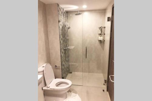 a bathroom with a toilet and a shower at Title Residence Naiyang Beach Phuket in Nai Yang Beach