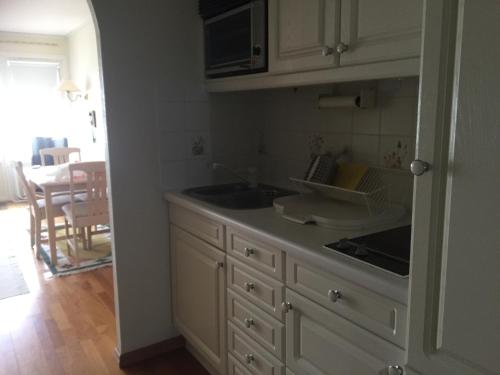 a kitchen with a sink and a counter top at Takvåning-Borgholm in Borgholm