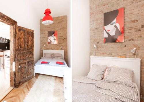 a bedroom with a bed and a brick wall at Little Whistle in the heart of Jewish district with AC in Budapest