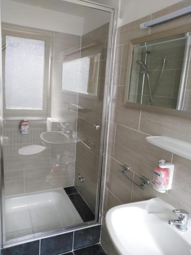 a bathroom with a shower and a sink at Hotel Berliner Hof in Düsseldorf
