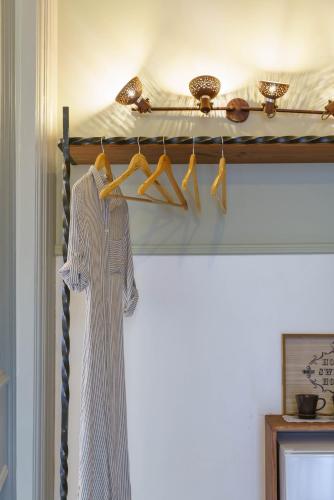 a dress is hanging on a rack in a room at Voulamandis House in Kambos