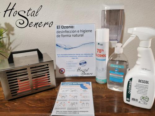 a table with a bottle of moisturizers and a air conditioner at Hostal Senero in Merida