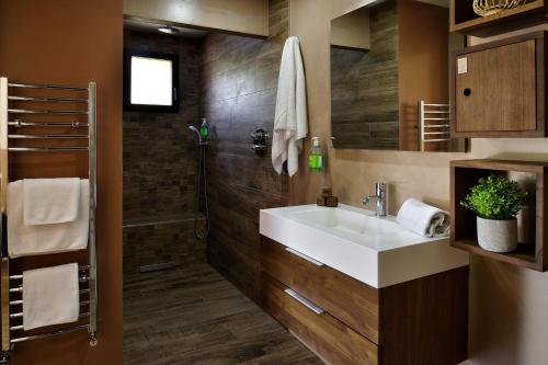 a bathroom with a sink and a shower at Résidence & Hotel U Livanti ECOLABEL in Propriano