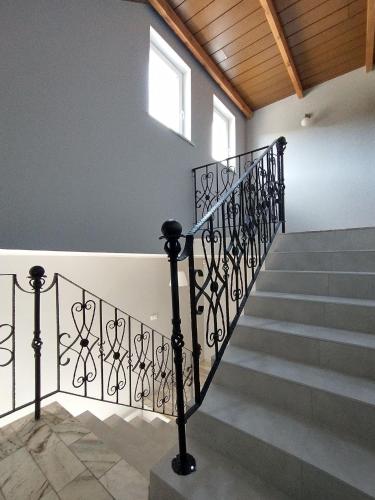 a staircase with wrought iron railings in a building at Willa Karwia in Karwia