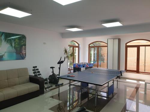 a living room with a ping pong table in it at casa adrian 2 mai in 2 Mai