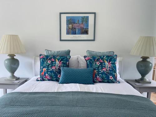 a bedroom with a bed with pillows and two lamps at The Old Flour Mill in Broadway