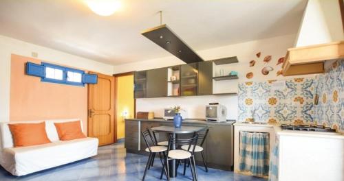 a small kitchen with a table and chairs in a room at camera azzurra San Vito Lo Capo in San Vito lo Capo