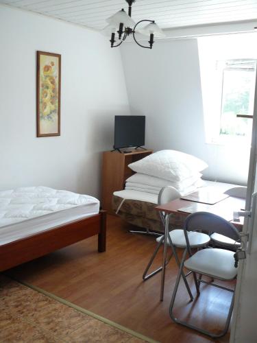 a room with two beds and a table and chairs at Villa pod Topolami in Okuninka