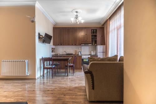 a living room and kitchen with a couch and a table at Apartment Chavchavadze in Batumi