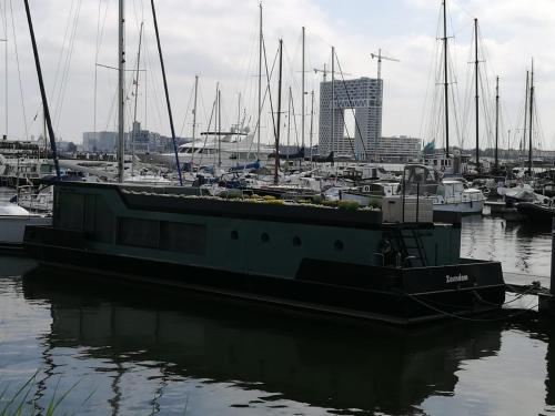 a boat is docked in a harbor with other boats at loft boat in Amsterdam