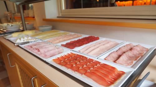 a buffet of different types of meats and vegetables at Frühstückshotel Margret in Maurach