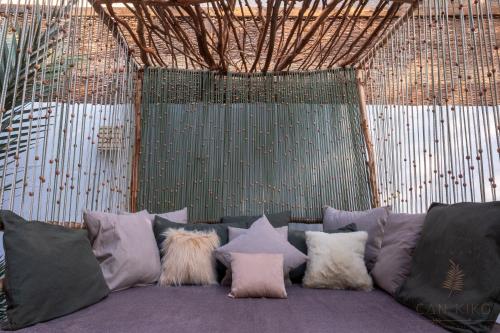 a couch with a bunch of pillows on it at Villa Can Kiko in Dahab